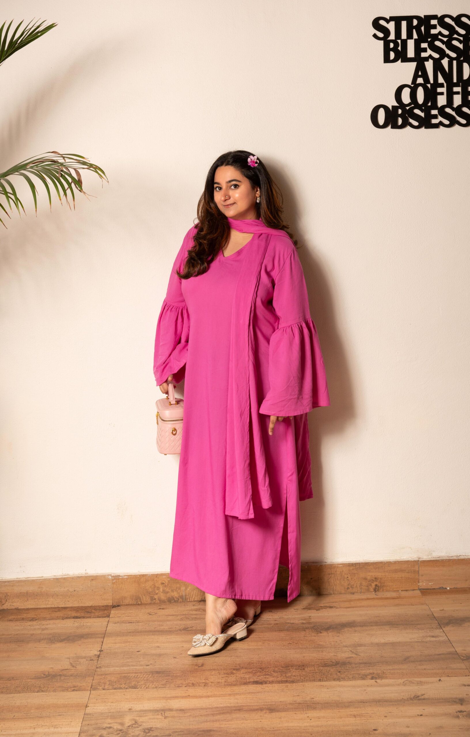Barbie Blush Kaftan Set – With Drape & Side Slit | Up to 5XL Woman wearing a Barbie pink V-neck kaftan dress with dramatic bell sleeves, matching drape, and a side slit, styled with a mini pink bag and pearl-embellished flats.